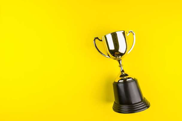 Golden trophy on yellow background.Concept championship. - Photo, Image