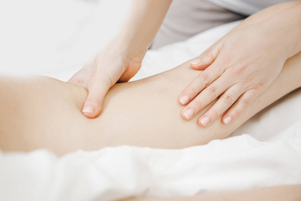 Anti varicose veins legs massage of young women beauty spa - Fotó, kép