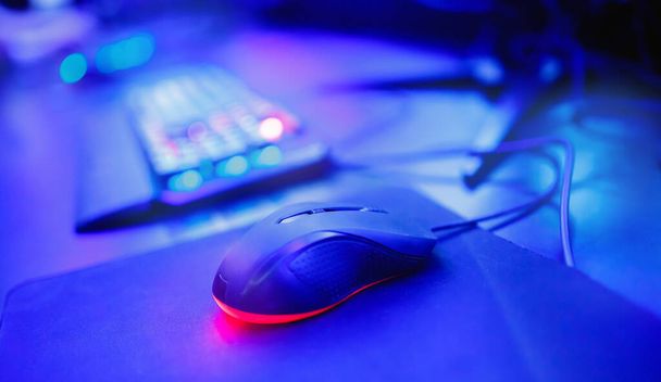 Keyboard and mouse for professional streamer video gamers with computer. Cyber sport championship, neon blue color lights - Fotografie, Obrázek