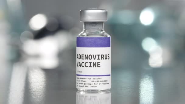 Adenovirus vaccine vial in lab slowing moving around the bottle. - Πλάνα, βίντεο