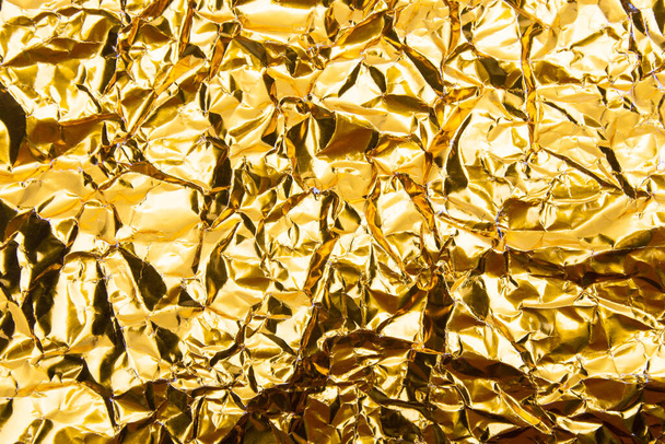 Gold crumpled foil paper texture background. - Fotoğraf, Görsel