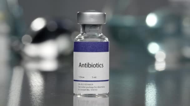 Antibiotics in vial in medical lab slowly rotating. - Video