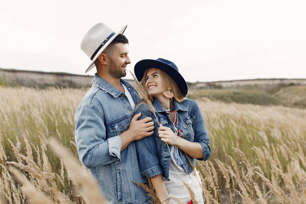 Very beautiful couple in a wheat field - Фото, зображення