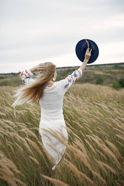 Beautiful elegant girl in a autumn wheat field - Photo, Image