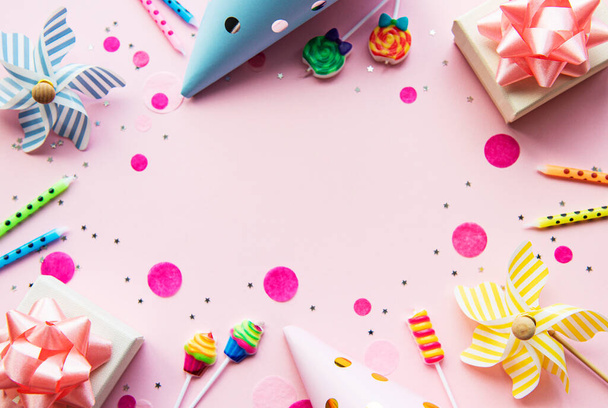 Happy birthday or party background.  Flat Lay wtih birthday balloons , confetti and ribbons on pink background. Top View.  Copy space. - Фото, изображение