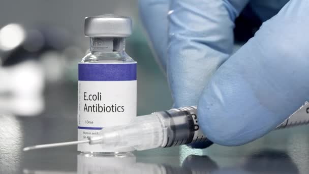 E.coli antibiotics vial in medial lab with syringe placed next to it. - Footage, Video