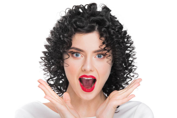 Portrait of beautiful curly hair brunette girl isolated on white background. Surprised emotional face, open mouth. - Photo, Image