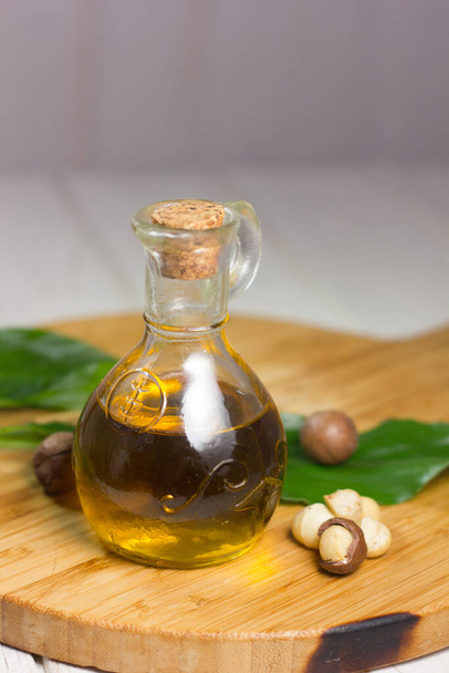 Macadamia oil in a glass bottle. Great photo for your needs. - Фото, изображение