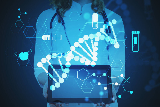 Unrecognizable woman doctor holding tablet over dark blue background with double exposure of creative coronavirus covid 19 treatment and vaccine search icons. Toned blurry image - 写真・画像