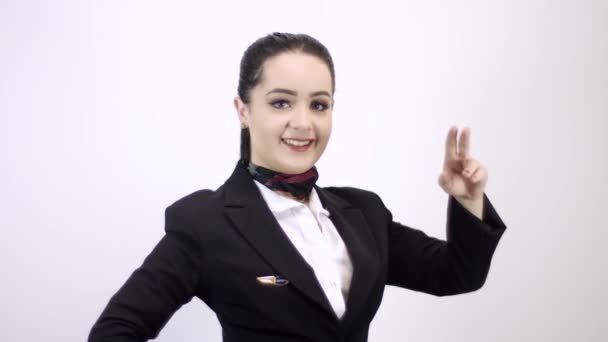 Cute stewardess in stylish costume gesturing posing isolated on white background - Séquence, vidéo