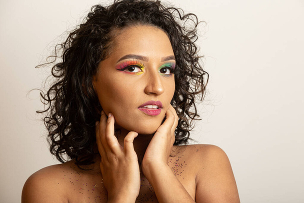 Beauty Fashion Model Girl with Curly Hair and Colorful Makeup. Afro woman smiling at the camera - Фото, изображение