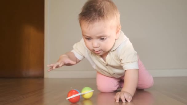 Cute infant girl playing with toy on floor - Felvétel, videó