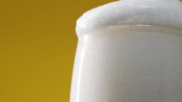 Pouring cold beer with fluffy foam in glass - Footage, Video
