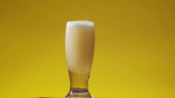泡がふわふわの冷たいビールをグラスに入れる - 映像、動画