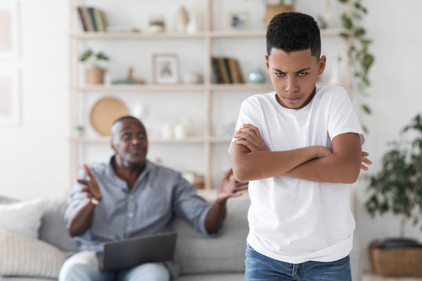 Family problems. Angry black grandfather shouting at his grandson at home - Photo, Image