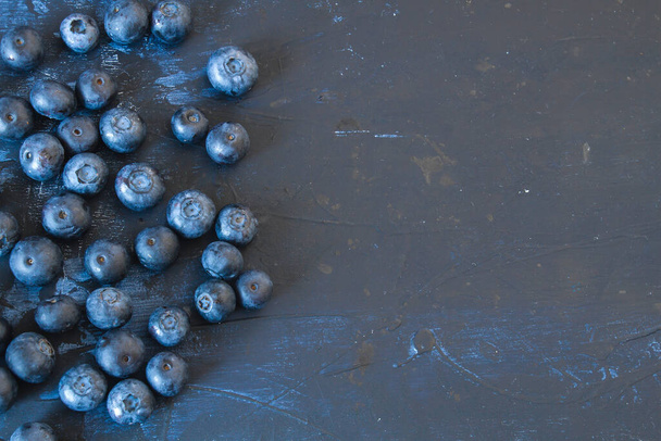 Fresh blueberries on dark surface - 写真・画像