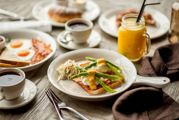 Breakfast with coffee toast with egg juice daylight cafe restaurant towel american wooden table bokeh - Fotoğraf, Görsel