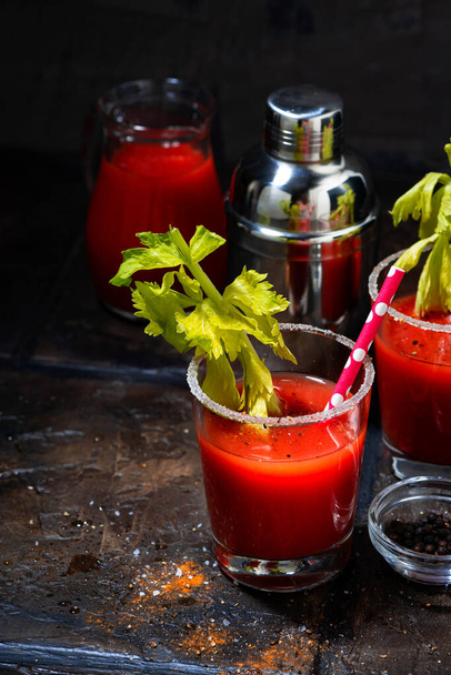 alcoholic cocktail bloody mary in glasses on dark background, vertical top view - Foto, Imagem