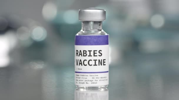 Rabies vaccine vial in medical lab slowly rotating. - Кадри, відео