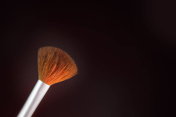One Makeup Brush on a black background                                - Foto, afbeelding