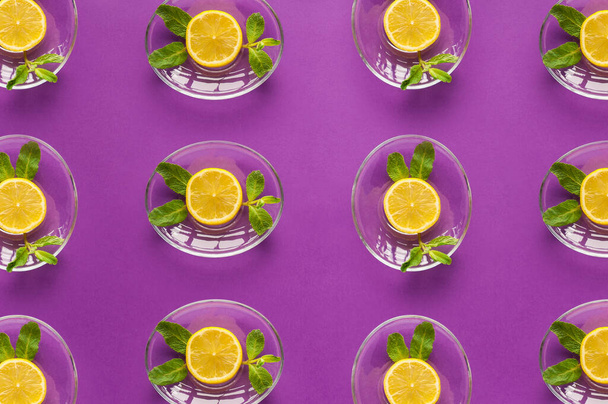 juicy vegetarian fruit pattern of lemon and mint on a purple background culinary - Photo, Image