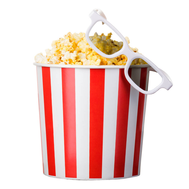 Paper striped bucket with popcorn and 3D glasses isolated on white background with clipping path. Concept of cinema or watching TV. - Photo, Image