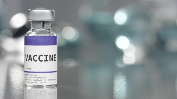 Vaccine vial in medical lab slowly rotating on left side. - Video, Çekim