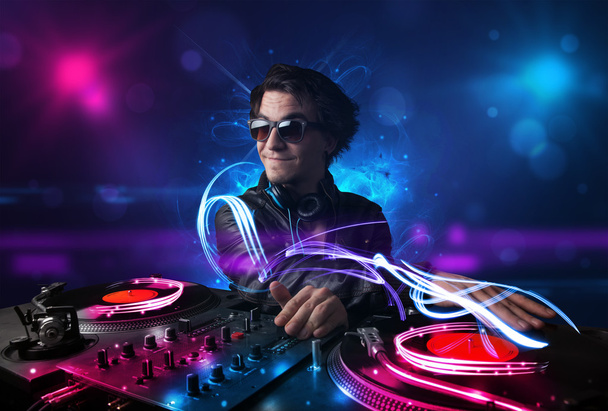 Disc jockey playing music with electro light effects and lights - Photo, Image