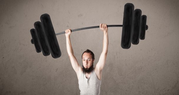Funny skinny guy lifting weights - 写真・画像