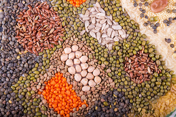 Food background. Stylized food map of various Legumes, sereals, beans, grain and seeds. Kind of lentils, bulgur, mash, chickpeas, sunflower seeds, couscous, rice. - Photo, Image