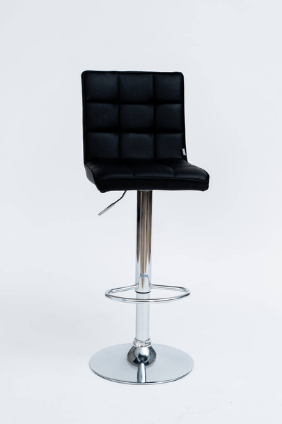 chrome-plated bar stool with black padded seat on with background - Photo, Image