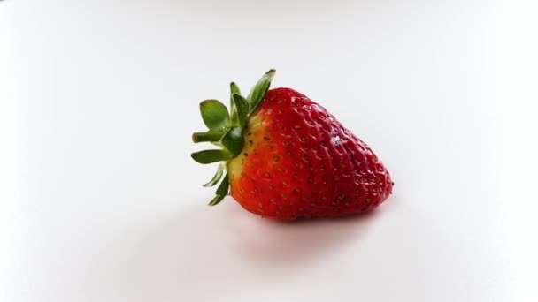 Fresh and ripe organic strawberry rotated on a white background.  - Video
