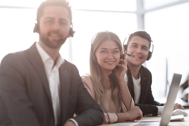 employees in a headset sitting at an office Desk. - Photo, Image