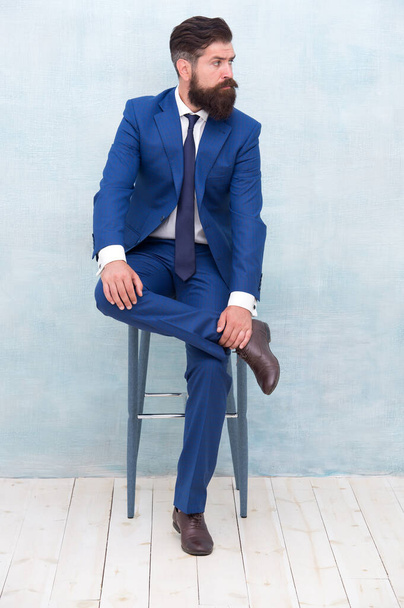 Classy and formal. Bearded man wear formal suit. Elegant lawyer sit on chair. Dressing up for business meeting. Formal event. Formal fashion style. Dress code. Office attire - 写真・画像