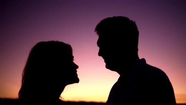 Lovely couple silhouettes kissing at the sunset - Footage, Video