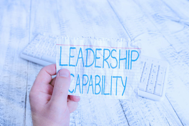 Conceptual hand writing showing Leadership Capability. Business photo text what a Leader can build Capacity to Lead Effectively Man holding colorful reminder square shaped paper wood floor. - Photo, Image