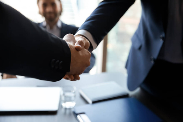 Close up employer shaking successful candidate hand at meeting - Photo, Image