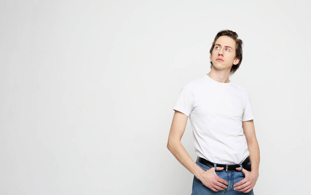 young man, white shirt, casual style, close up over white background. - 写真・画像