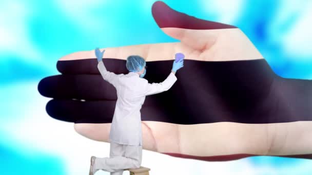 Krankenschwester in medizinischer Maske und Handschuhen wäscht große Hand, bemalt in den Farben der thailändischen Flagge. Der Staat sorgt für die Gesundheit der Nation. Waschen Sie sich die Hände. Virenschutz. Prävention von Krankheiten. - Filmmaterial, Video