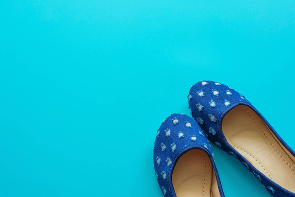 Vintage blue pair of polka dot shoes on a blue background. - 写真・画像