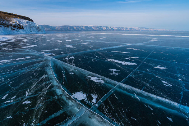 Baikal frozen lake in winter season with cracks on ice floor, Siberia, Russia, Asia - Fotografie, Obrázek