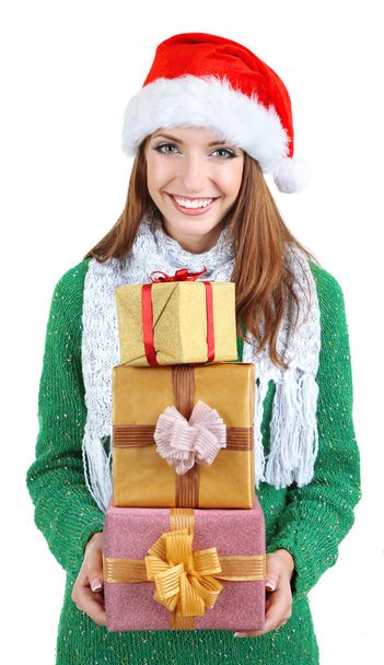 Beautiful smiling girl in New Year hat with gifts isolated on white - Фото, изображение