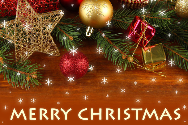 Beautiful Christmas decorations on fir tree on wooden background - Foto, Bild