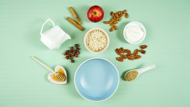 Healthy breakfast concept with oats, yogurt, fruit and nuts. Top view flatlay. - 写真・画像