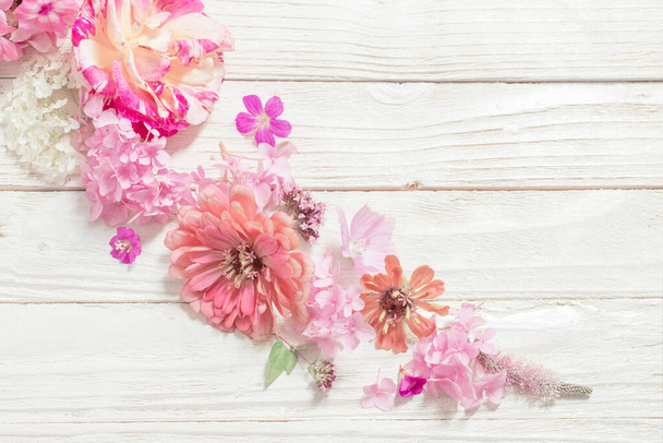 pink flowers on white wooden background - Фото, изображение