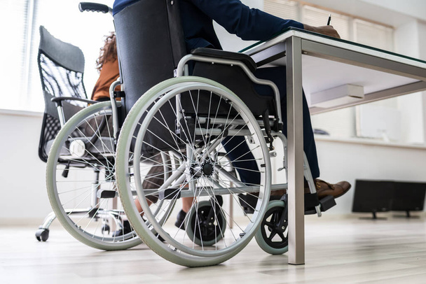 Disabled Businesswoman Sitting On Wheelchair In Office - Valokuva, kuva