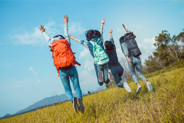 Group of Young Asian women jumping enjoy travel trekking to destination in vacation time for go to camping. - Фото, изображение