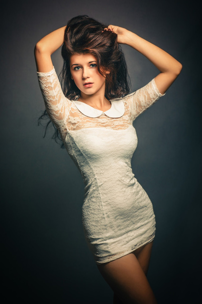 Mulher bonita menina vestido branco no fundo cinza, cabelo exuberante
 - Foto, Imagem
