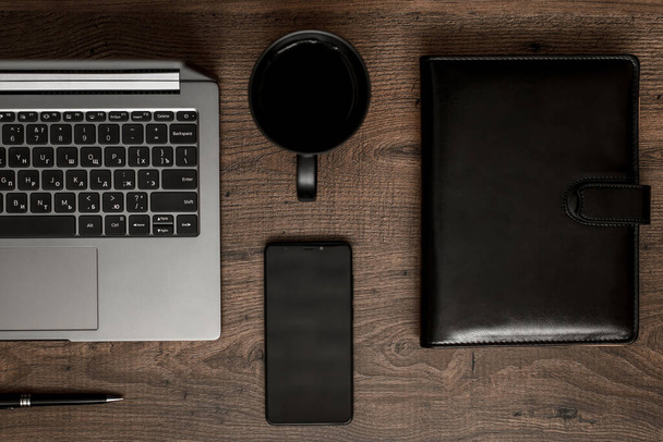 workplace composition with laptop, smartphone, notepad, coffee and pen - Фото, зображення