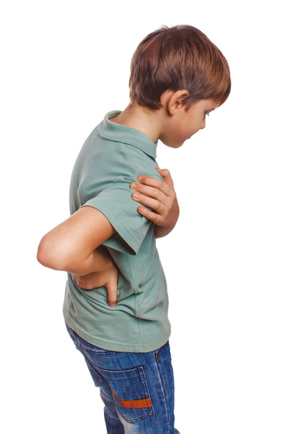 Osteocondrosis adolescente sostiene su mano detrás de su dolor de espalda
 - Foto, Imagen